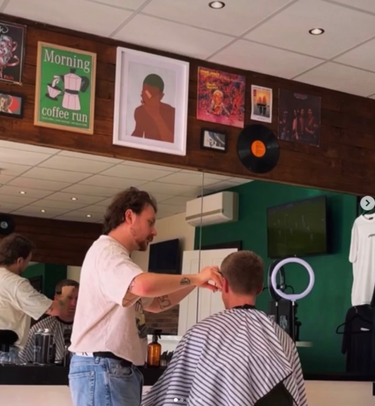 Ewan cutting a client's hair inside the REFINED salon