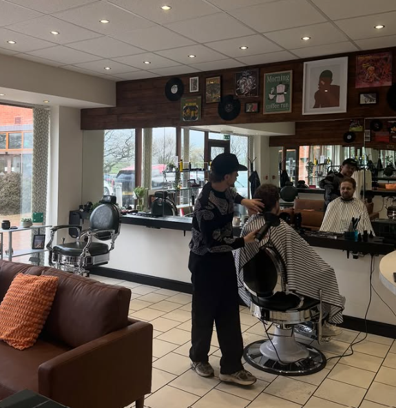 Ewan cutting a client's hair on the REFINED shop floor