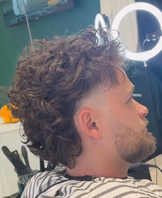 Curly hair skin fade cut by Ewan at REFINED
