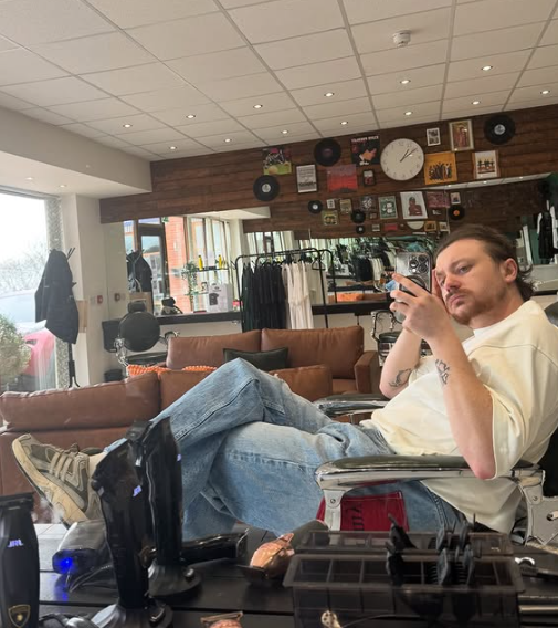 Ewan relaxing in the barber chair inside the REFINED shop